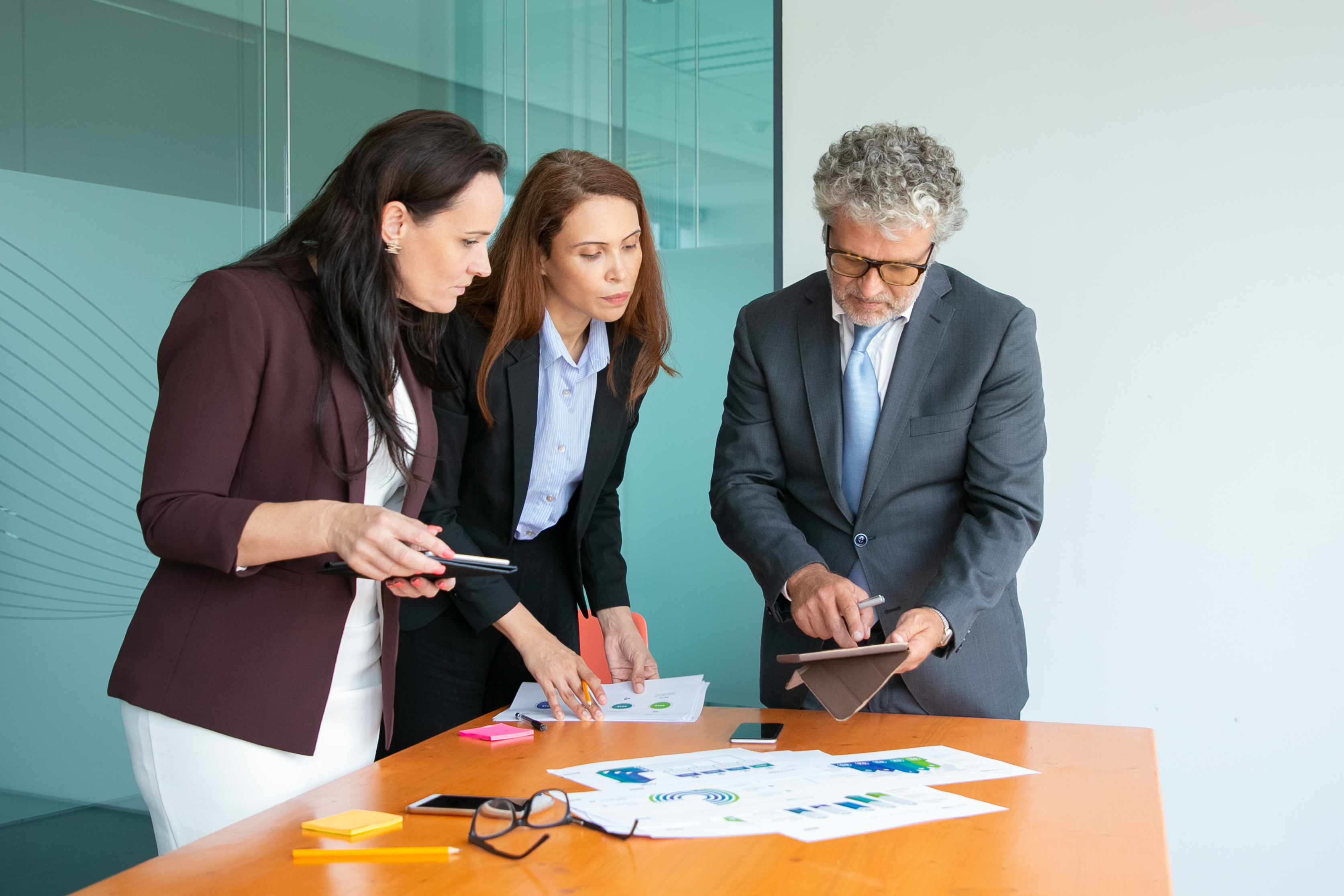 Consulting team collaborating around a workspace